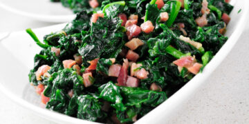 closeup of a bowl with spanish espinacas con jamon, spinach with ham