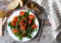 Arugula and crushed tomato salad with garlic and cumin dressing