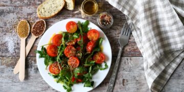 Arugula and crushed tomato salad with garlic and cumin dressing