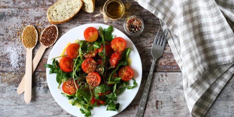Arugula and crushed tomato salad with garlic and cumin dressing
