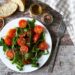 Arugula and crushed tomato salad with garlic and cumin dressing